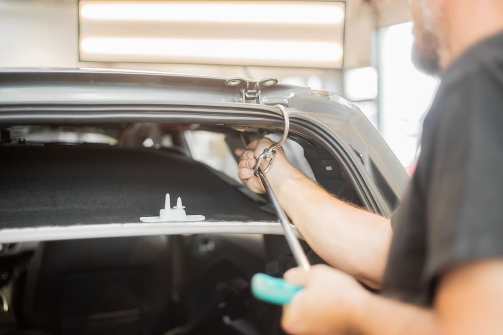 Image of a technician repair a vehicle.